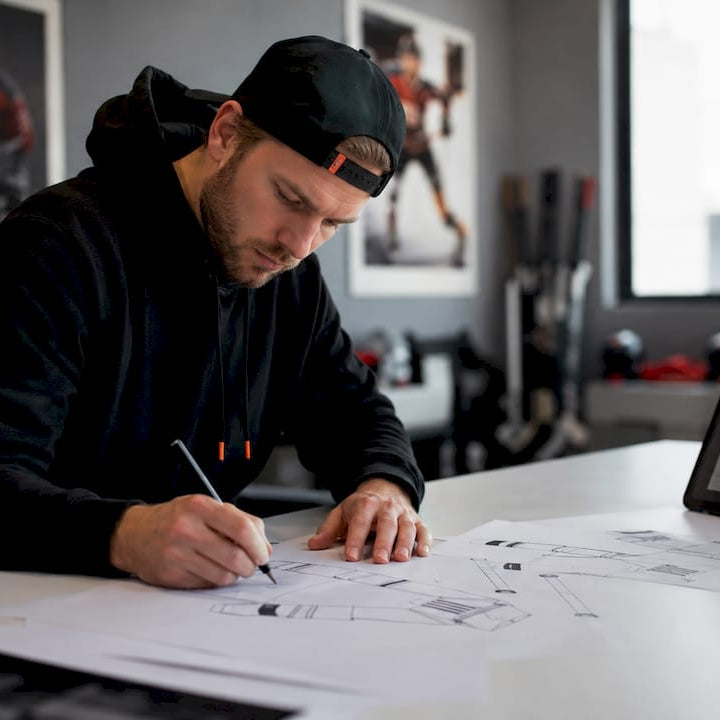 Youth hockey coach designing custom apparel at table