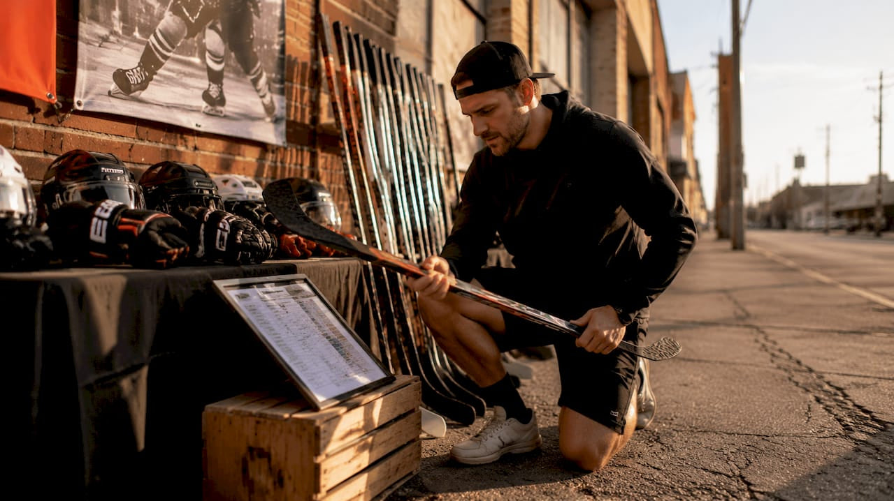 Man examining hockey gear alternatives in store