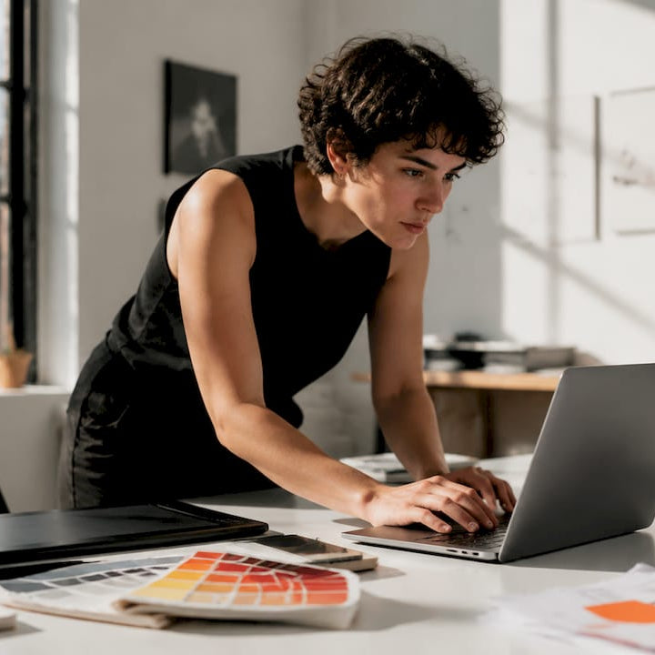 Designer uploading team logo to laptop