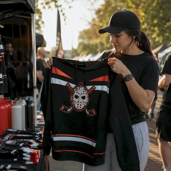 Woman inspecting limited edition hockey hoodie in store