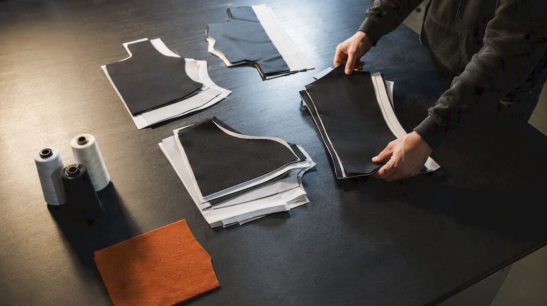 Small custom apparel order bundles on worktable
