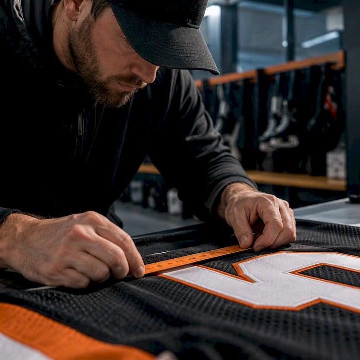 Coach measuring youth jersey number placement