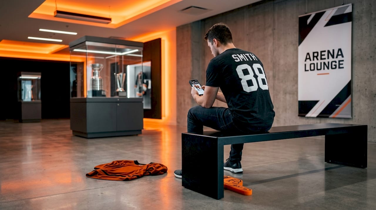 Hockey fan wearing personalized shirt sitting on bench