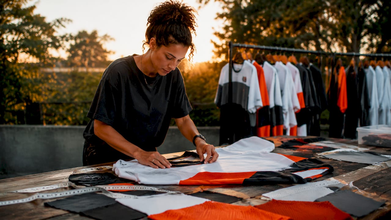 Designer inspecting logo placement on hockey jersey