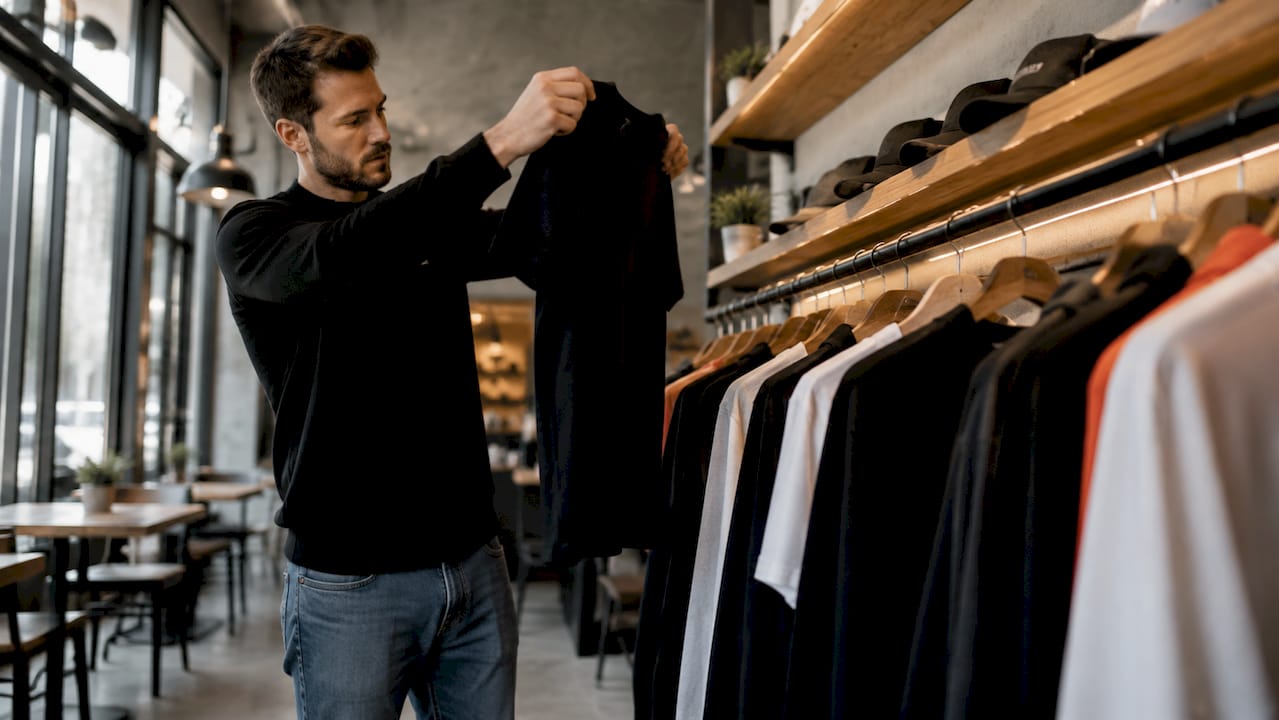 Man browsing hockey slang apparel in store