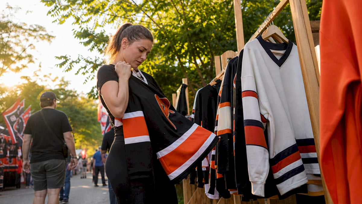 Fan choosing hockey apparel in store