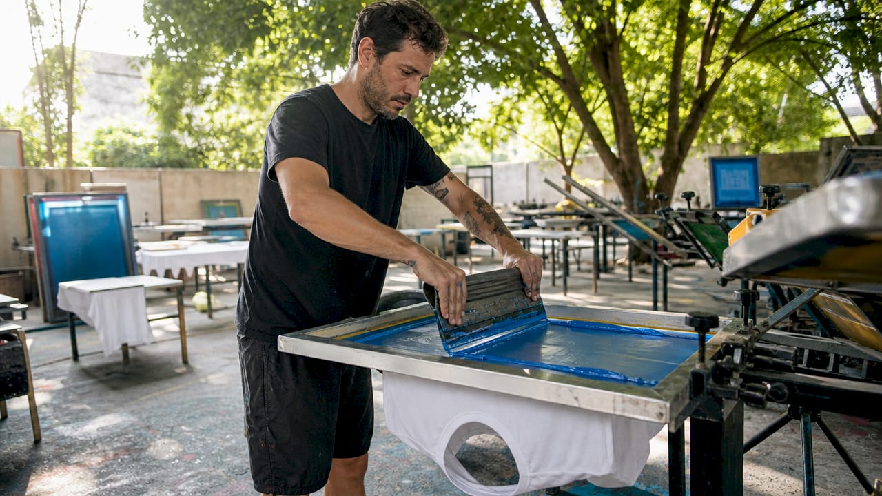 Technician performing screen printing on t-shirt