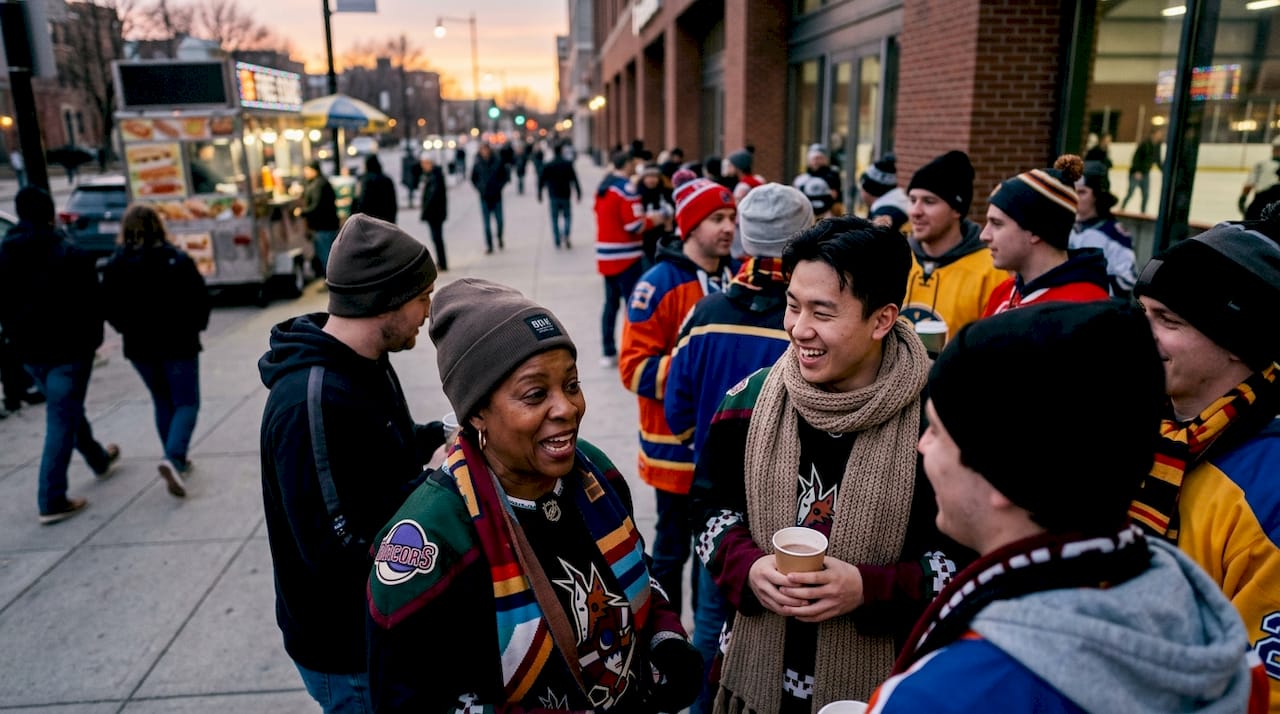 Diverse hockey fans wearing team apparel outdoors