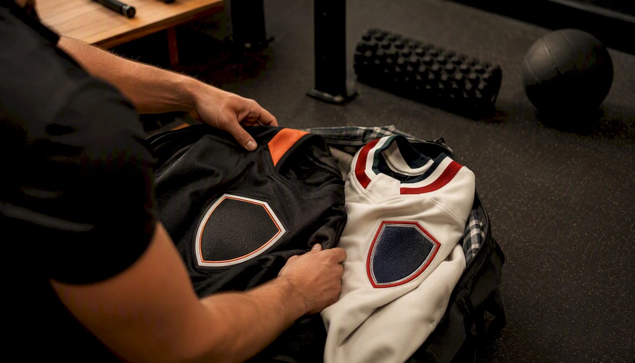 Hands sorting hockey jerseys side by side