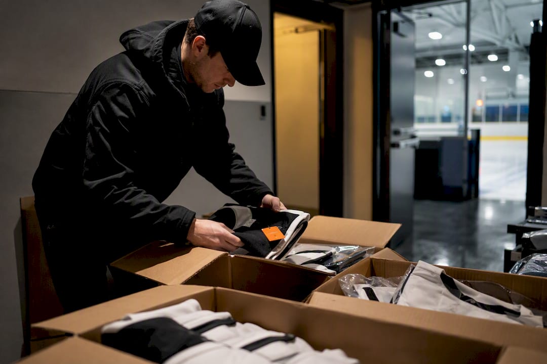 Manager receiving team gear at rink