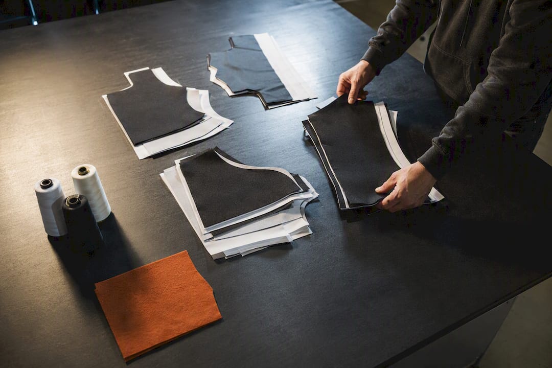 Small custom apparel order bundles on worktable